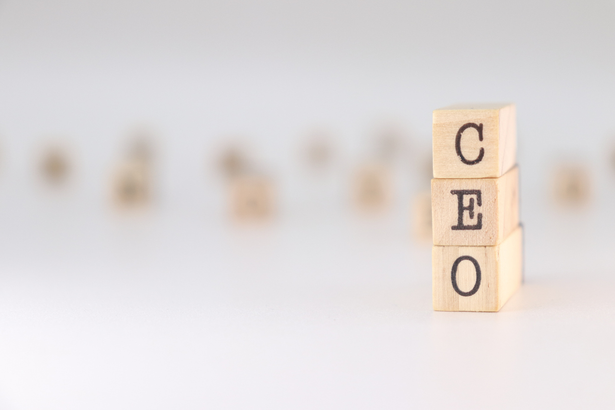 Acronym CEO written on wooden cubes isolated on white background . Concept text for chief executive officer